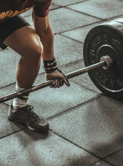 Close-up of a barbell deadlift in a gym