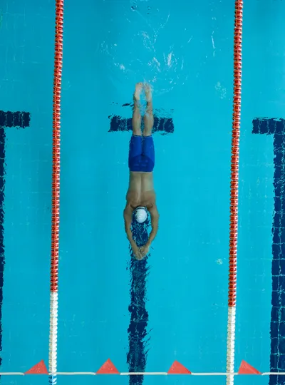 Aerial view of swimmer doing butterfly stroke in a lane pool