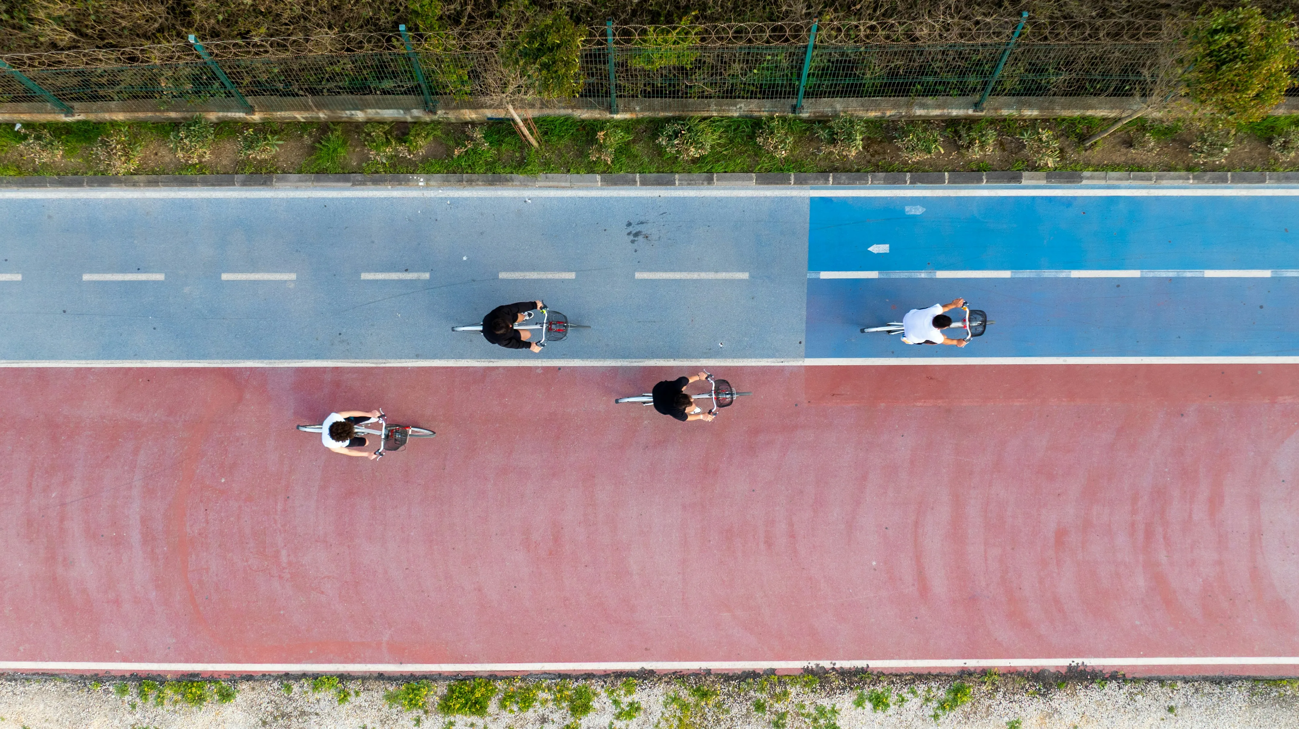 Aerial view of runners on an athletics track, representing the quantified athlete tracking every metric
