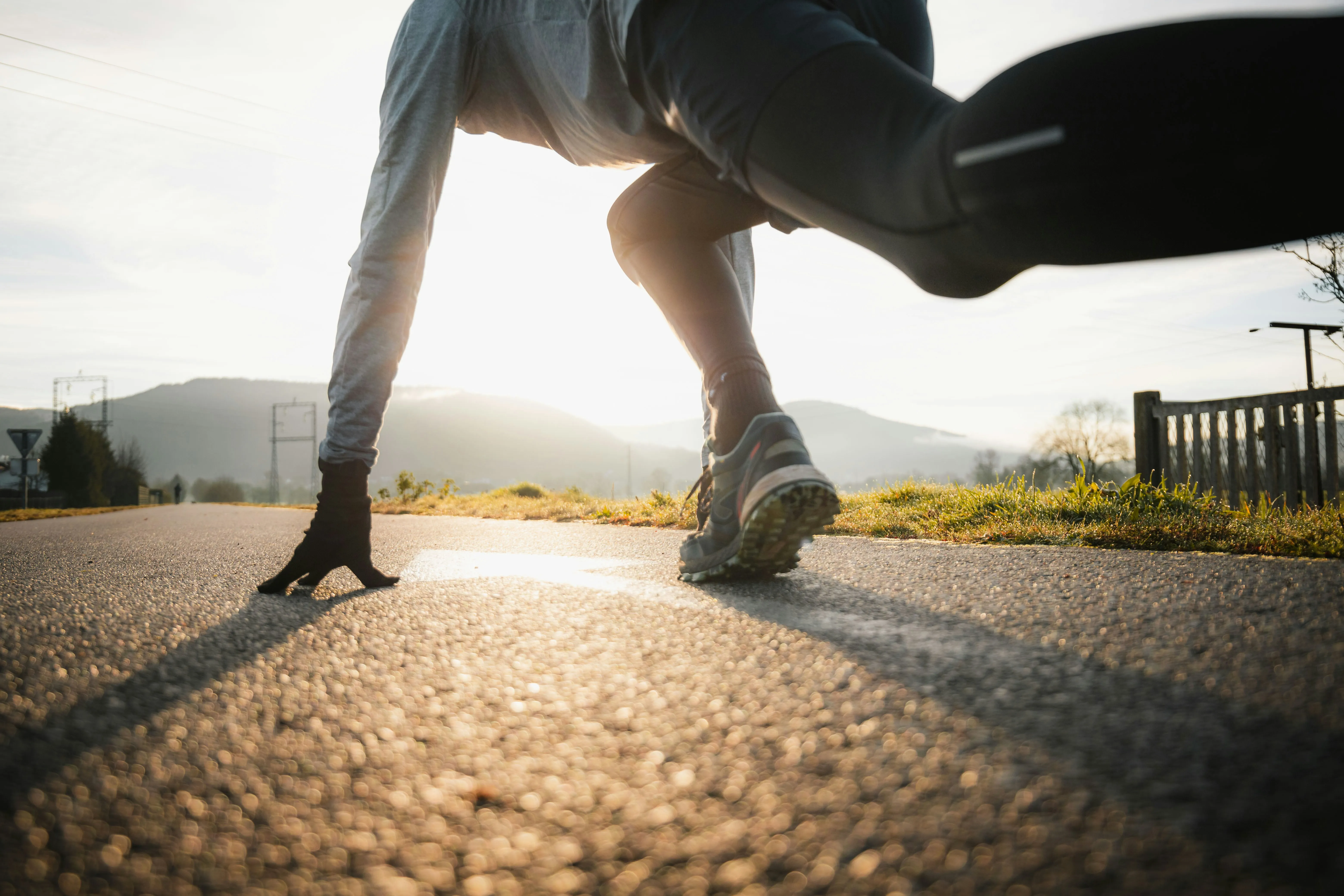 Close-up of a runner's legs on a road, focusing on the biomechanics behind running metrics