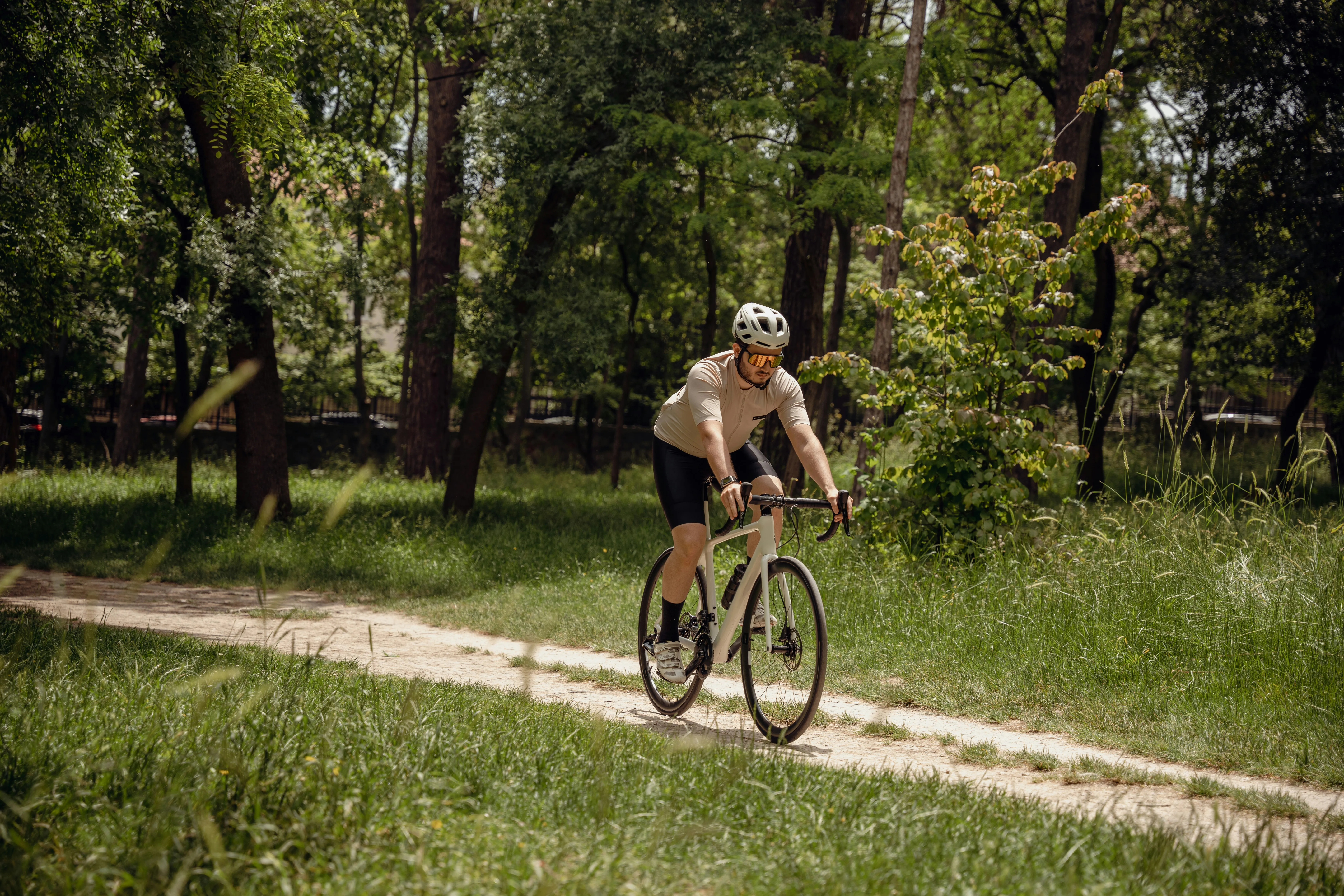 Cyclist riding through a forest path, pushing aerobic capacity in a VO2 max effort